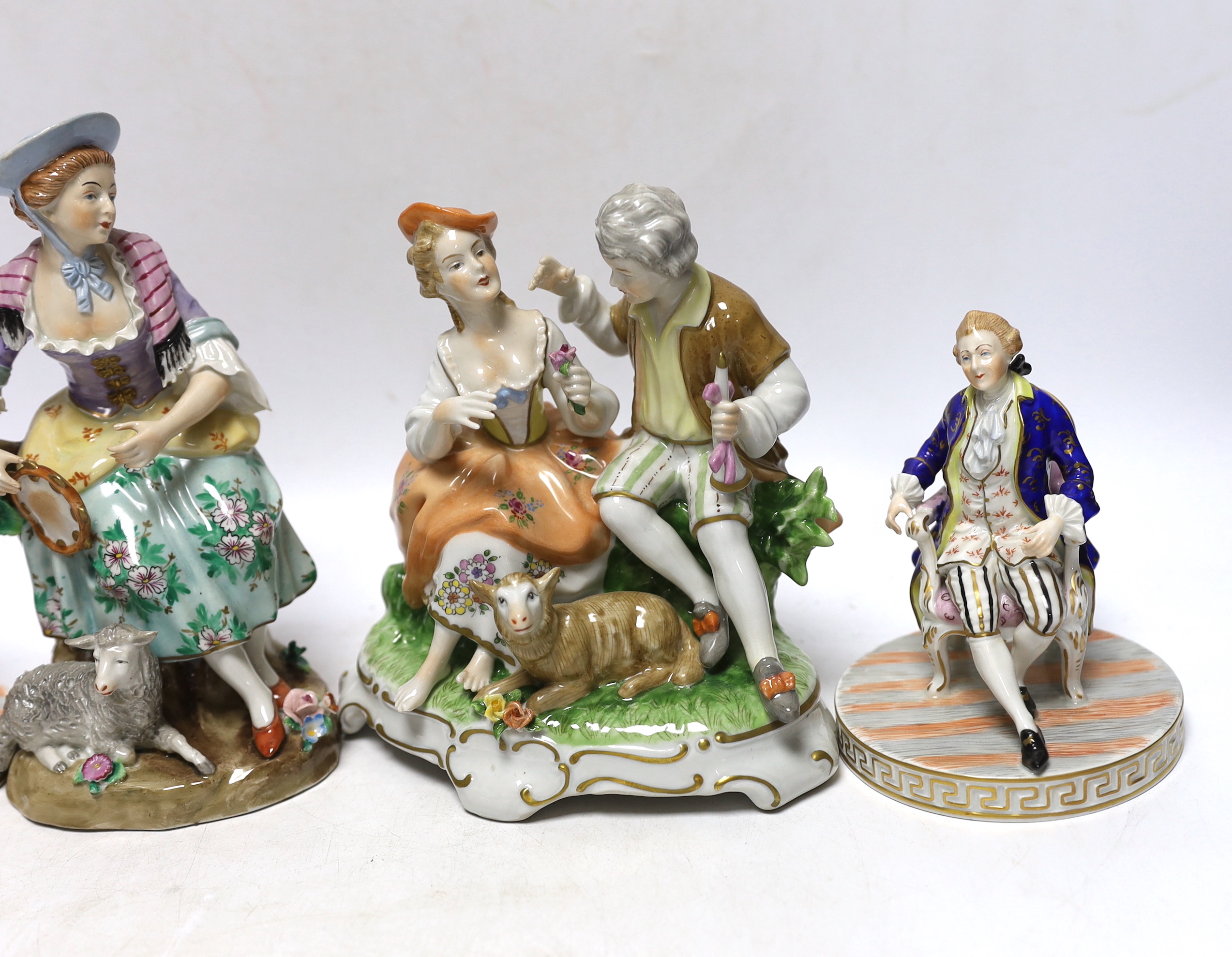 A pair of Dresden figures, a Sitzendorf shepherdess group and another German group